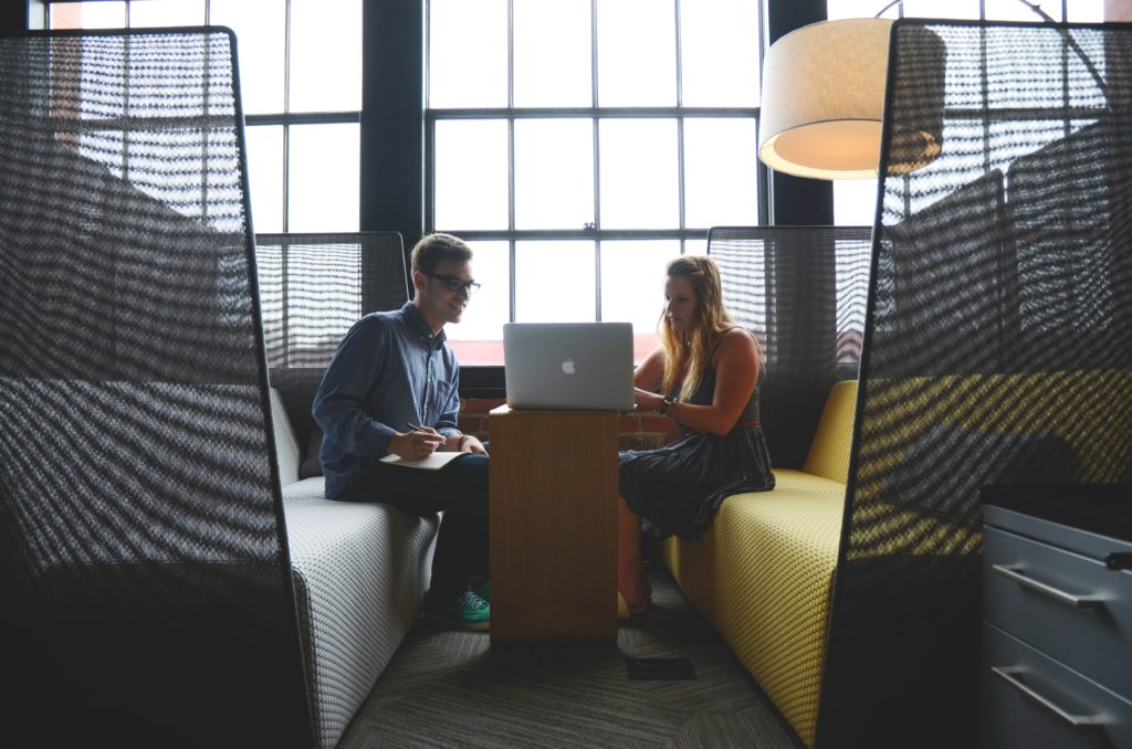 Image of man and woman working, representing inviting guests to become a pro blogger