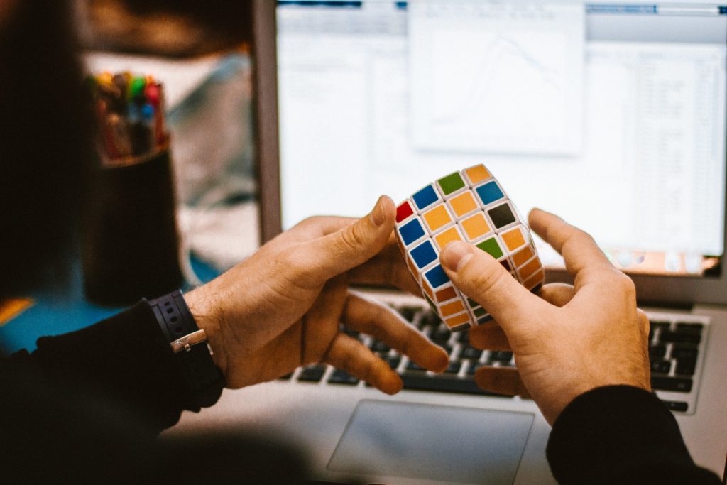 Man solving Rubik's Cube representing the strategy behind Writing a blog post